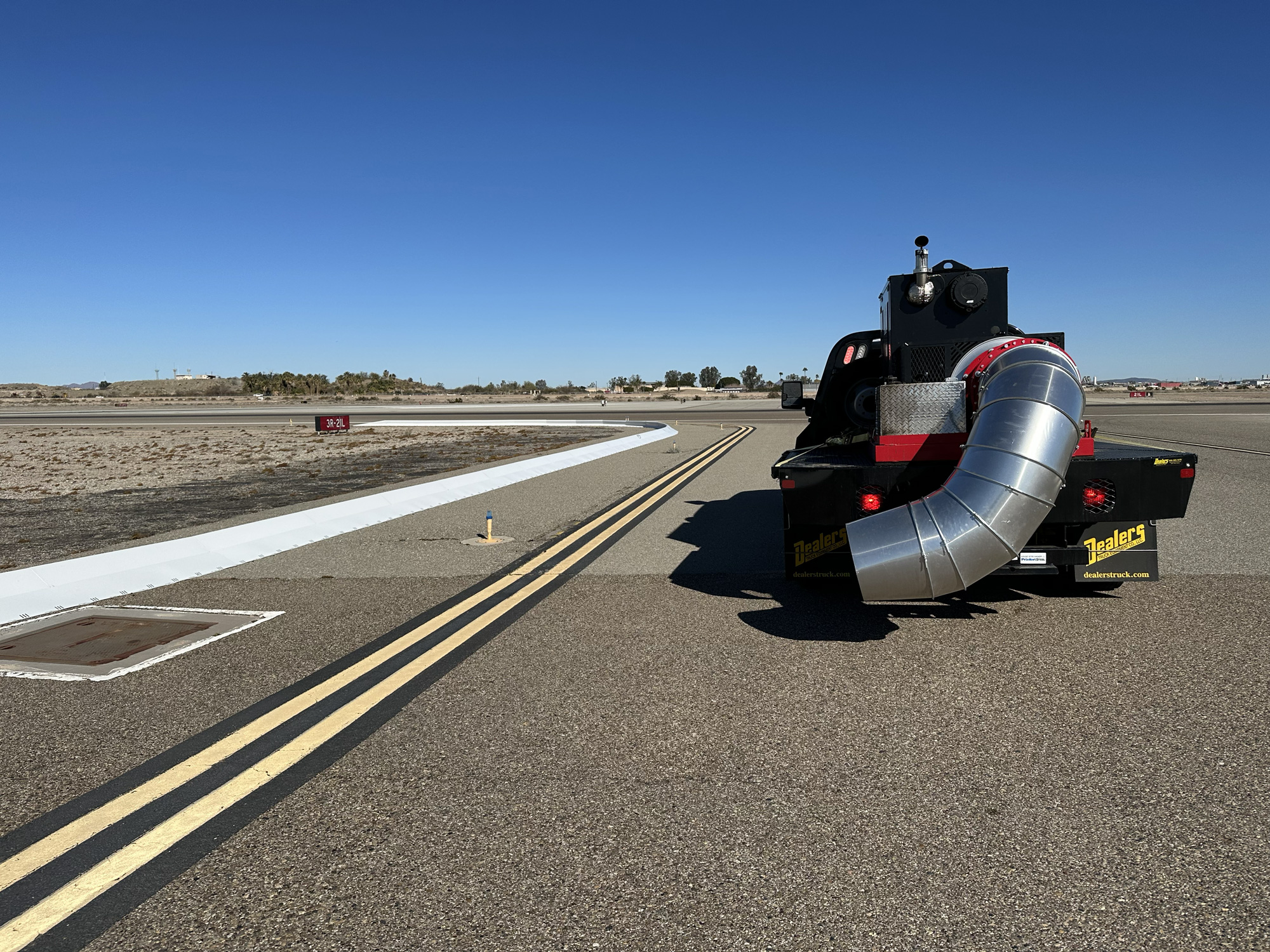 Commercial airport runway safety system with collapsible FOD barrier preventing aircraft engine damage
