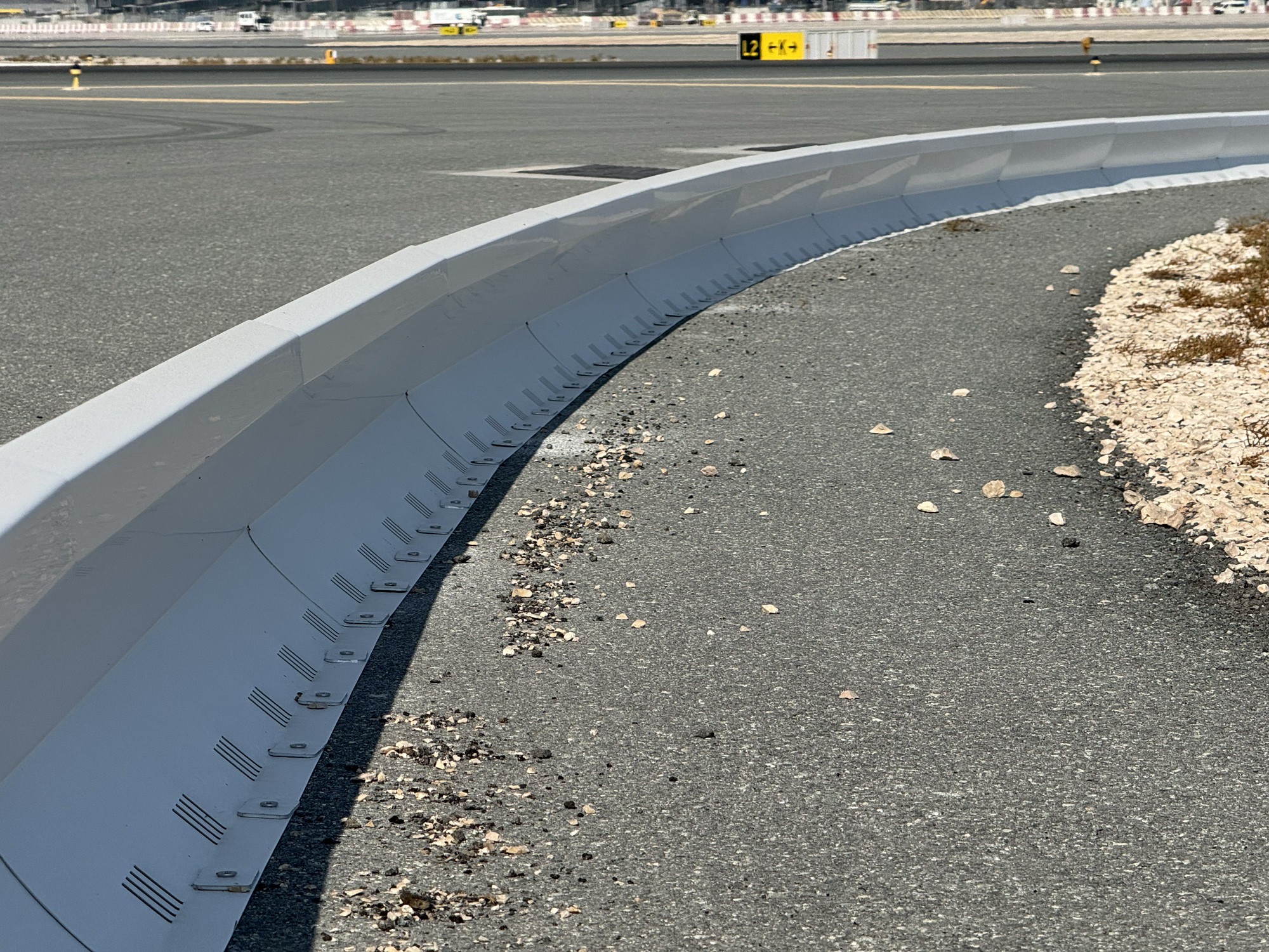 Commercial airport runway safety system with collapsible FOD barrier preventing aircraft engine damage