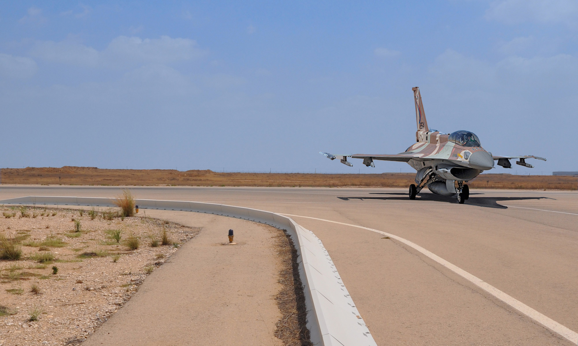 F-16 fighter jet protected by military-grade FOD barrier system on combat airfield