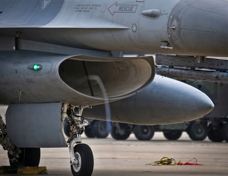 Fighter jet engine air intake demonstrating FOD ingestion risk and debris suction hazard